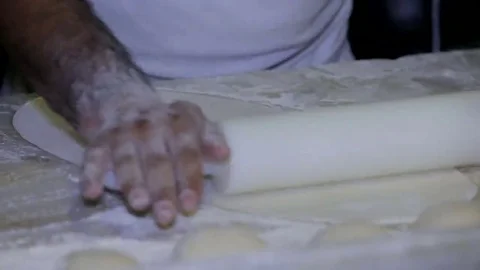 Baker making bread, man hands, kneading dough, cooking coat Stock Footage 69124380