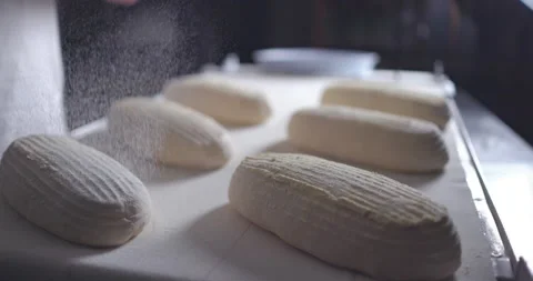 Baker making bread from sourdough with natural ingredients. Hands sieves flour Stock Footage 153120316