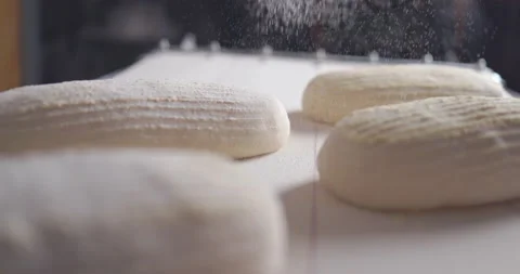 Baker making bread from sourdough with natural ingredients. Hands sieves flour Stock Footage 153124031