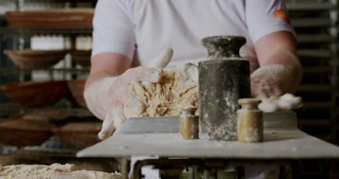 Baker making bread, weighing dough, traditional baking. 4K. Video stock 221561573
