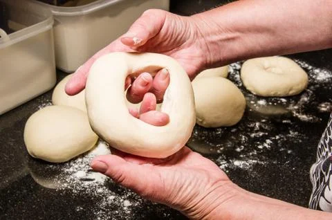 Baker making fresh bagels 写真素材