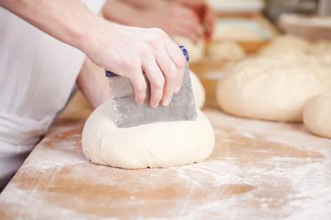 Baker making traditional patterns on bread Stock Photos