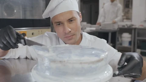 Baker man Using Spatula Making Cake decoration Stock Footage 125050622