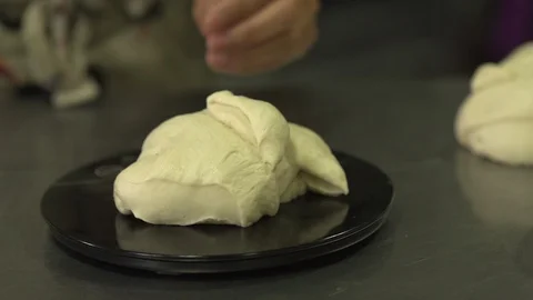 Baker measures dough on electric scale Stock Footage 128460711