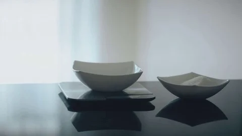 Baker measures portion of sugar scales on table in kitchen indoor. Stock Footage 81158460