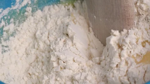 Baker mixing flour and eggs in slow motion Stock Footage 310029695