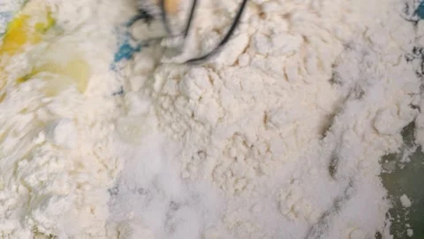 Baker mixing flour and eggs in slow motion Stock Footage 310030253