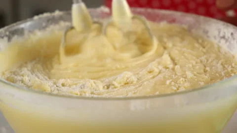 Baker mixing flour into batter with electric mixer cooking biscuit dough. Stock Footage 311528834