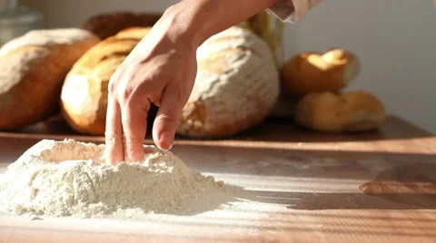 Baker mixing flour on table, dolly shot Stock Footage 10735255