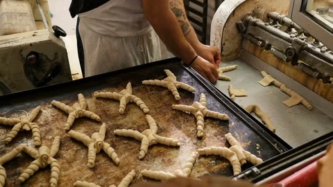 Baker models the bread coming out of the mixer Stock Footage 76125995