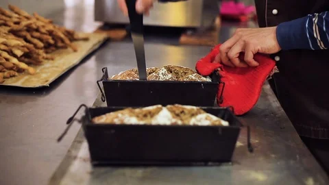 The Baker opens the bakeware with fresh bread from the oven Stock Footage 106464653