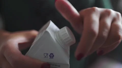 Baker opens pack of milk products for cooking Stock Footage 143584874