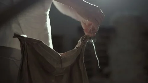 The baker opens a paper bag at the mill Stock Footage 143980567