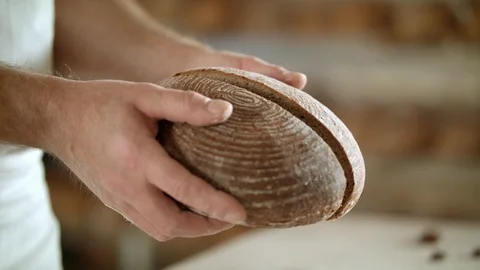 Baker opens steamy bread out of the oven Video stock 93100187