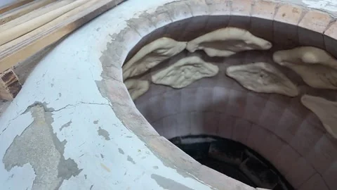Baker Placing Dough Inside Traditional Tone Oven Stock Footage 342268059