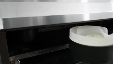 Baker Placing Fruit Cake Tin Inside Commercial Oven Close Up 스톡 동영상 343020267