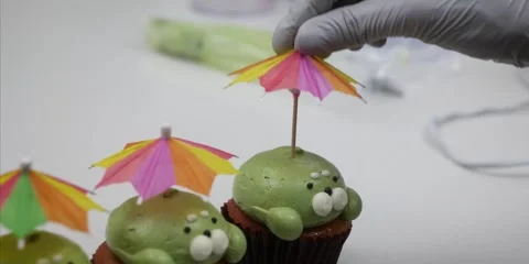 Baker Placing Miniature Umbrella on Cute Animal Cupcake - Close Up Stock Footage 343588821