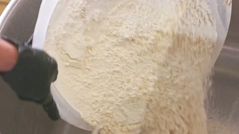 The baker pours flour from the pelvis Stock Footage 155523289