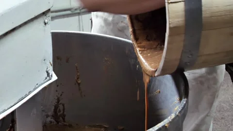 The baker pours the sourdough for bread into the kneader. Stock Footage 245560168