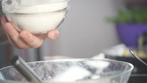 Baker pours sugar into flour to make dough for pie, cake, pizza, pancakes. 動画素材 124751357