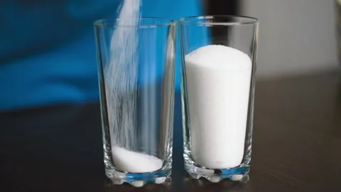 Baker pours sugar into measuring cup Stock Footage 143584843