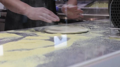 Baker prepares the basis for pizza in front of visitors to the cafe Stock Footage 119785910