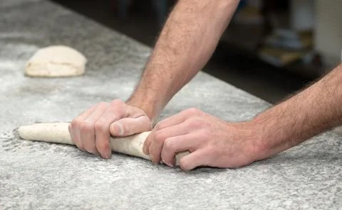 Baker prepares bread dough, close up on his hands Stock Photos