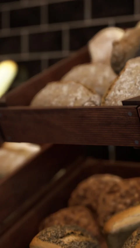Baker prepares bread loaves for customers in a bakery shop Stock Footage 340643789