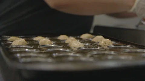Baker prepares cookies in a baking tray Stock Footage 104872395