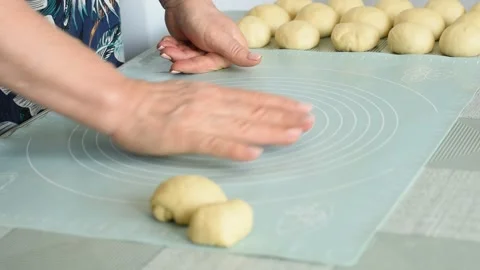The baker prepares the dough for baking with his hands. Stock Footage 250466587