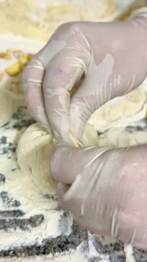 Baker prepares dough buns filled with apples and sugar Video stock 331983082