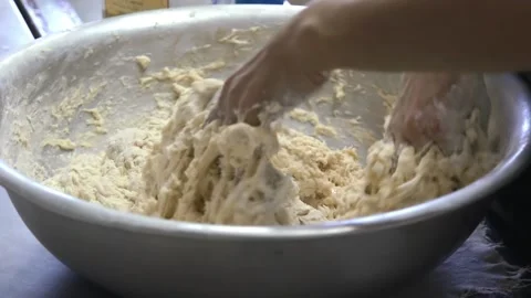 Baker prepares the dough by hands Stock Footage 143585226