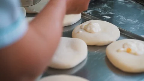 A baker prepares fresh breads and cakes. Stock Footage 93063265