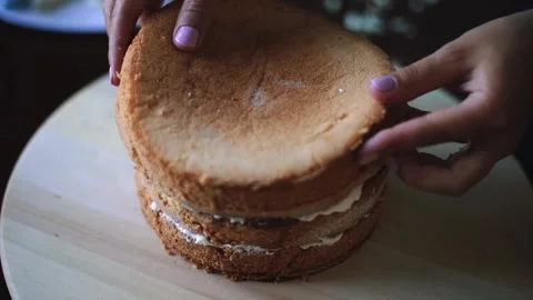 Baker prepares layered sponge cake Stock Footage 143584844