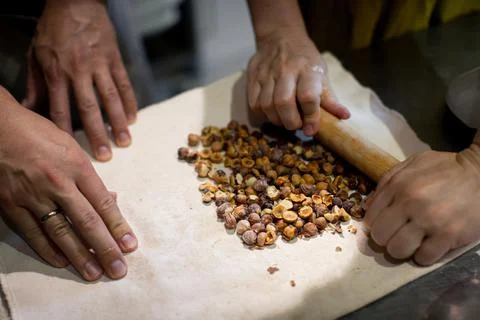 Baker prepares nuts in dough Stock Photos