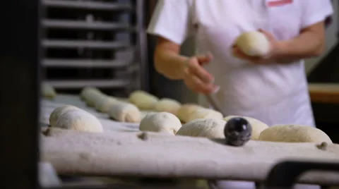Baker prepares raw bread for baking Stock Footage 68837816