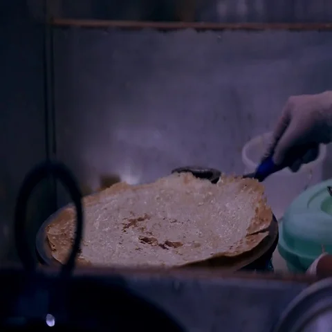 Baker preparing Arabic bread on griddle. Stock Footage 69405125