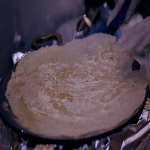 Baker preparing Arabic bread on griddle. Stock Footage 69405406