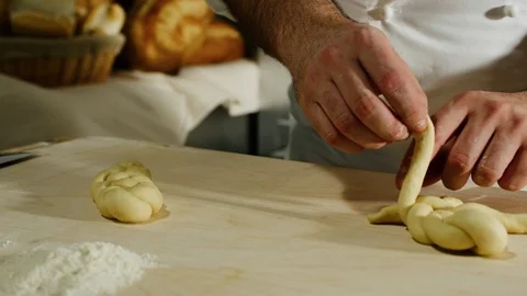 A baker preparing a braid of bread 4k Stock Footage 86892876