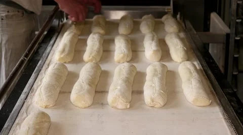 Baker preparing the bread dough before placing in hot oven Stock Footage 64470653