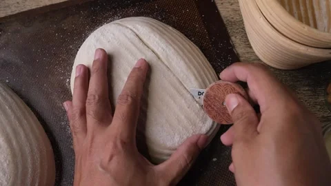 Baker preparing bread dough for scoring. Stock Footage 297946233