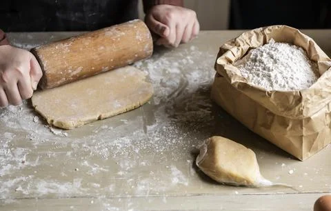 Baker preparing dough with a rolling pin Stock Photos
