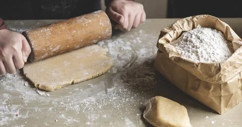 Baker preparing dough with a rolling pin Stock Photos
