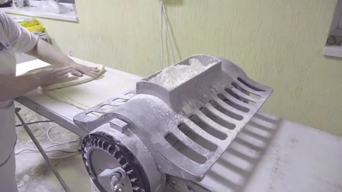 Baker preparing flaky at dough roller machine in bakery HD slow-motion video Stock Footage 74727740