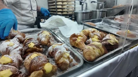 Baker preparing fresh pastries in a kitchen Stock Footage 268764751