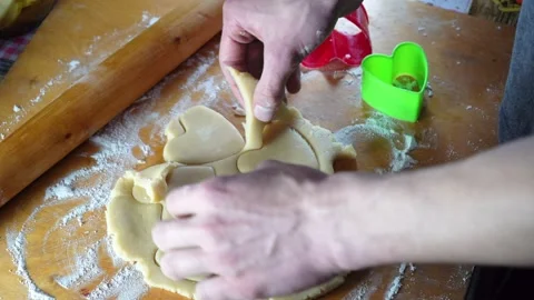 Baker preparing homemade heart shaped cookies on the table. Cutting biscuits Stock Footage 233810906