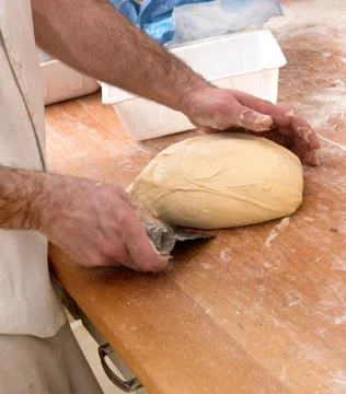 Baker preparing a loaf of bread Stock Photos