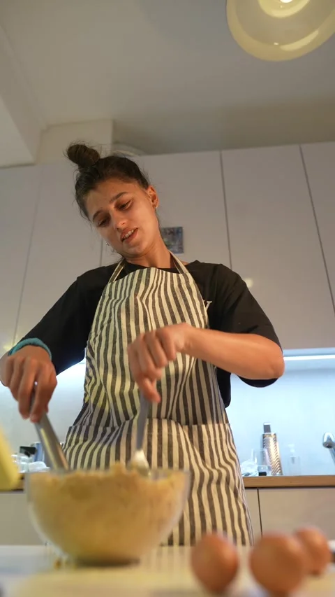 Baker preparing mixture. Person blending ingredients in cozy kitchen Stock-Footage 346481295
