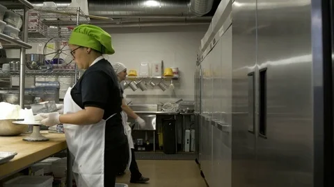 Baker presenting cakes to camera 動画素材 77080143