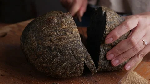 Baker Presenting charcoal sourdough bread. Video stock 309873885